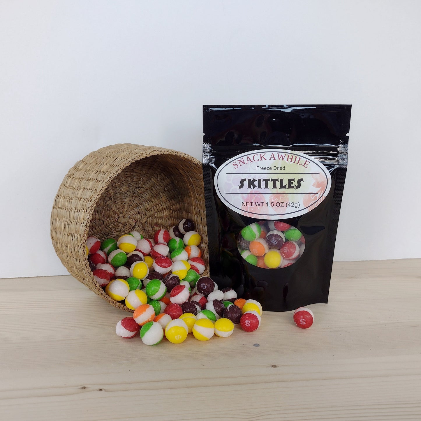 Snack Awhile freeze dried skittles candy flowing from a basket